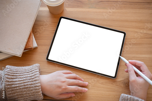 Top view image of a woman using a digital tablet at her desk. people and technology concepts