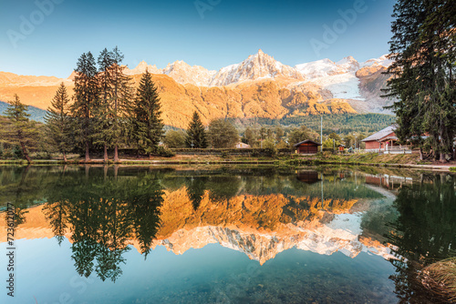 Lac des Gaillands with Mont Blanc massif and train at station in the sunset at Chamonix, France