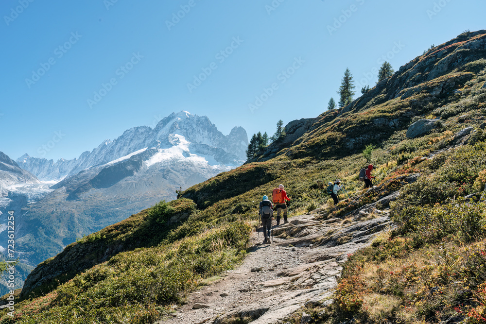 Group of hiker hiking on summit trail amidst the French alps on sunny day at France