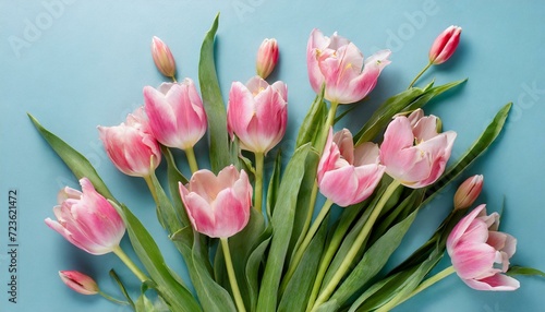 pink tulips in a vase.a beautiful composition of spring flowers. Arrange a cheerful bouquet of pink tulips on a pastel blue background, infusing the scene with a sense of joy and renewal.