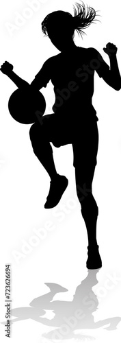 A female soccer football player woman in silhouettes