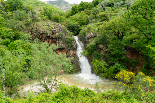 Water stream of mountain waterfall flowing between picturesque rocks