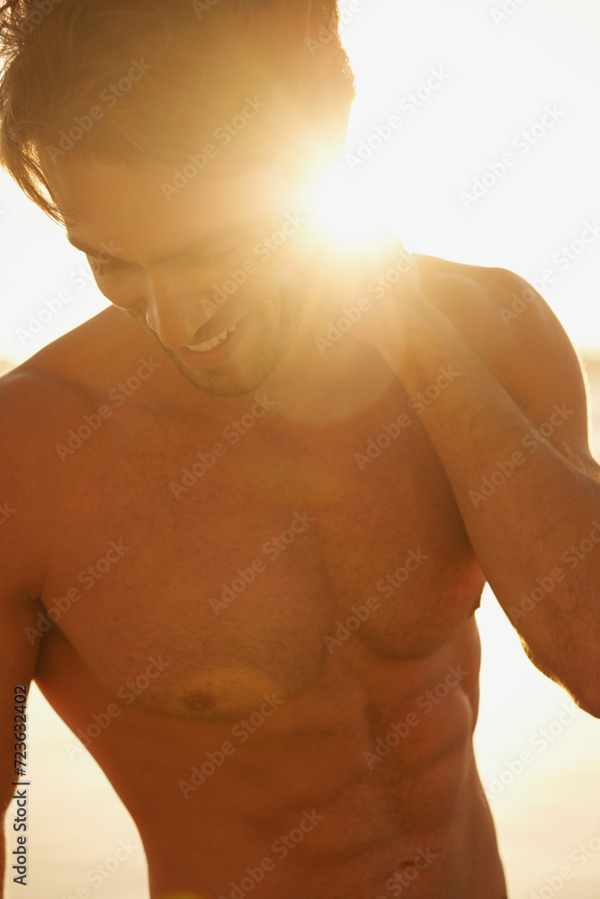 Man, shirtless and happy on beach at sunset, confidence and tourist at sea on summer holiday. Male person, lens flare and outdoor adventure for fun, calming ocean and peaceful environment in nature Man, shirtless and happy on beach at sunset, confidence and tourist at sea on summer holiday. Male person, lens flare and outdoor adventure for fun, calming ocean and peaceful environment in nature