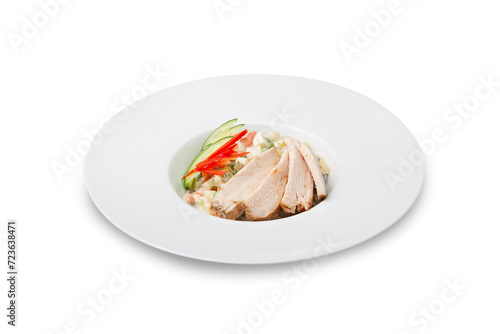 Olivier salad with chicken on a plate, isolated