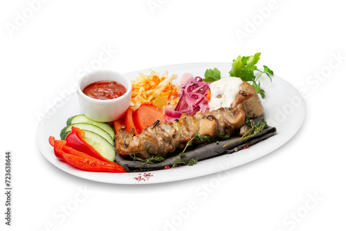 Chicken kebab with fresh vegetables on a plate, isolated
