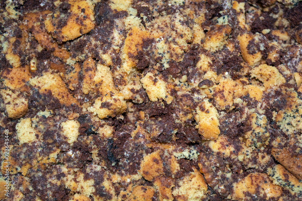 Crushed layers of biscuit dough with raisins and poppy. Cakes preparation process Crushed layers of biscuit dough with raisins and poppy. Cakes preparation process