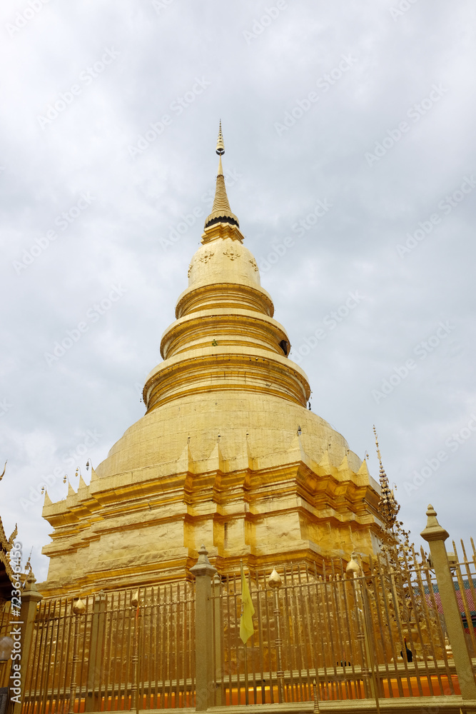 Naklejka premium beautiful golden stupa at Wat Phra That Haripunchai temple at Lamphun province, Thailand
