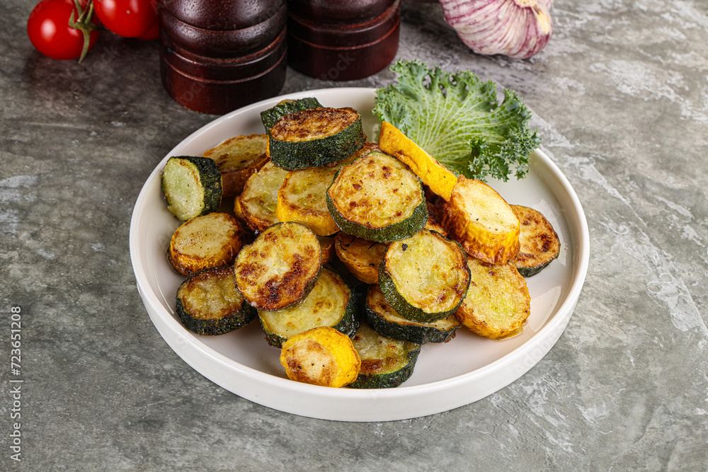 Roasted young zucchini in the plate