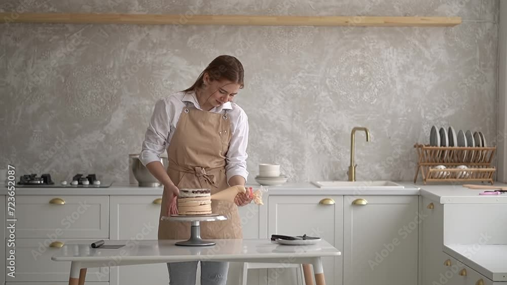 woman with red hair. prepares a cake.pastry cream in sleeve.pastry cream.High-quality shooting in 4K format woman with red hair. prepares a cake.pastry cream in sleeve.pastry cream.High-quality shooting in 4K format
