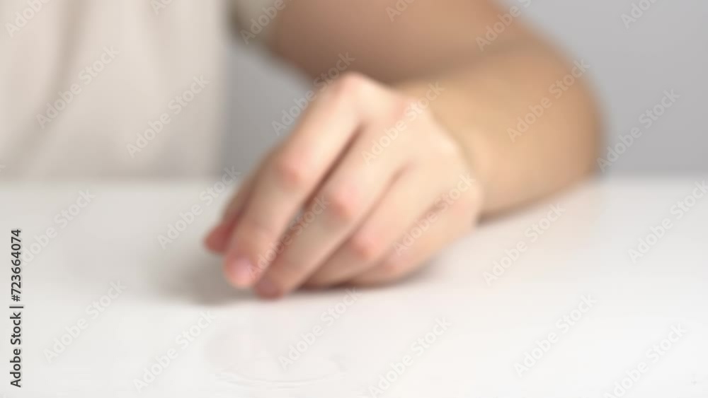 A woman's hand takes a glass with a dissolved effervescent pill. A woman takes a glass of effervescent vitamin C