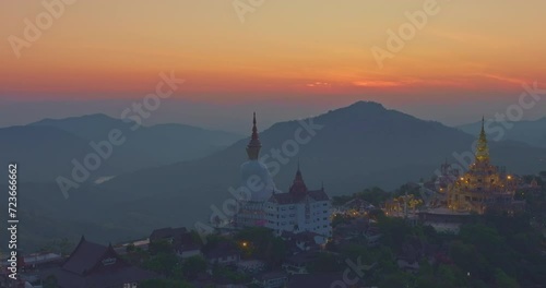 .Aerial view beautiful golden pavilion at Wat Phachonkeaw at sunrise..5 sitting buddha statues of Phachonkeaw on Khao Kho hill the beautiful landmark .and famous in Phetchabun Thailand. photo