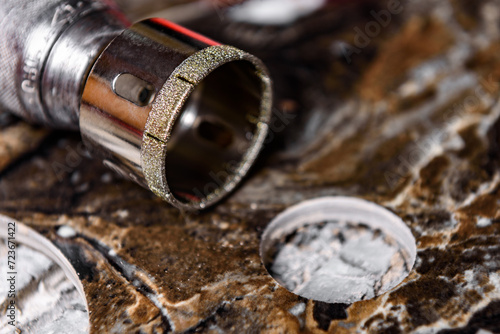 Diamond core drill on black marble tile.  photo