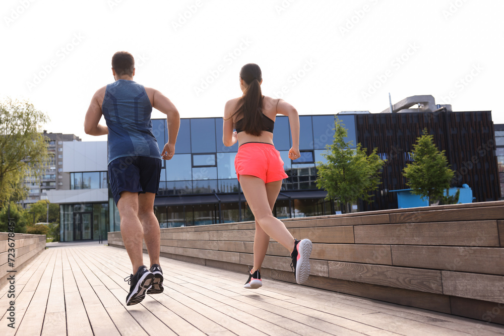 Healthy lifestyle. Couple running outdoors, low angle view