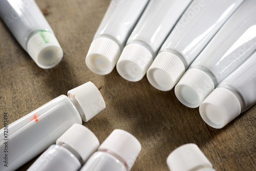 Small paint tubes on wooden table