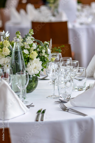 Table setting. Glasses and flowers on the table. Restaurant.