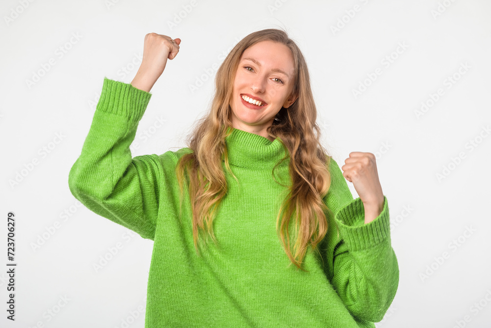 Enthusiastic woman winning and rejoicing, celebrating victory, dancing, success concept, achieve goal and triumphing, white background Enthusiastic woman winning and rejoicing, celebrating victory, dancing, success concept, achieve goal and triumphing, white background