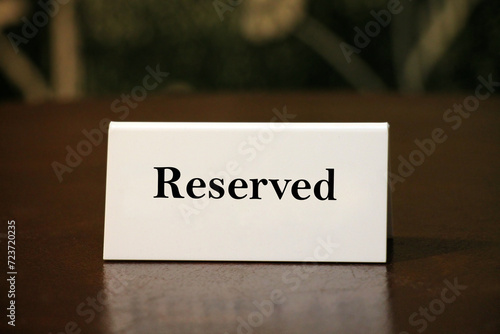 Reservation card on wooden table closeup.