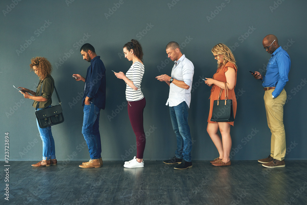 Obraz premium Businesspeople, hiring and waiting in line with technology or recruitment, onboarding or internet. Men, women and corporate diversity or cellphone in queue or interview, human resources or employment