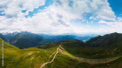 Aerial view at the Koruldi lakes. Green hills  high mountain pastures. Summer day. in the background are the snowy peaks of the Caucasus Mountains. High resolution panorama