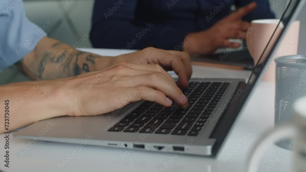 Close up of hands of male developer coding on laptop at office Close up of hands of male developer coding on laptop at office