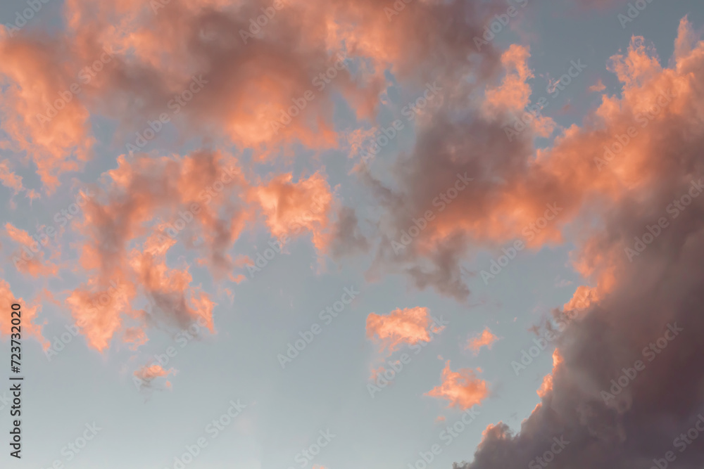 Dramatic cumulus clouds on sunny day at sunset painted in purple with sun. Atmosphere multicolor background or wallpaper Dramatic cumulus clouds on sunny day at sunset painted in purple with sun. Atmosphere multicolor background or wallpaper