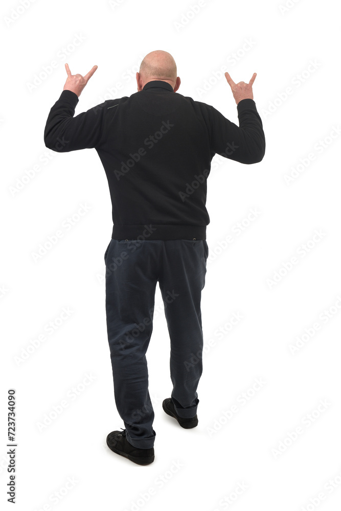 rear view of a man showing the horns sign with fingers on white background rear view of a man showing the horns sign with fingers on white background