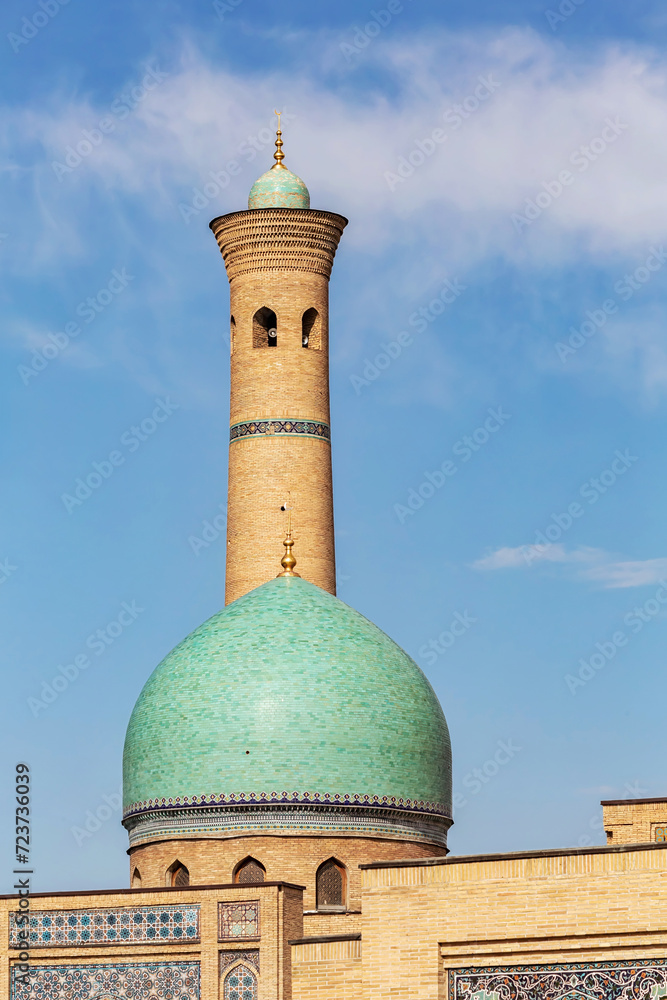 Hazrati Imam mosque. Main dome and minaret, close up, blue sky at background. Vertical. Tashkent, Uzbekistan