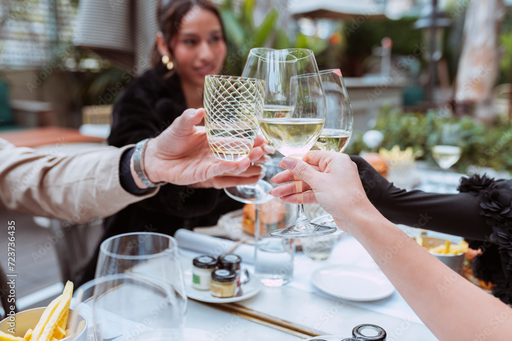 Hands holding glasses and toasting, peeople cheers clinking wine ...