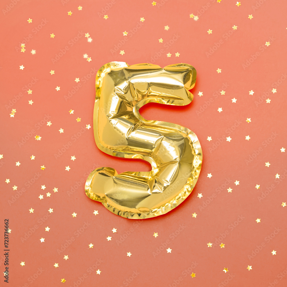Number 5 of Golden foil balloon on orange background Number 5 of Golden foil balloon on orange background