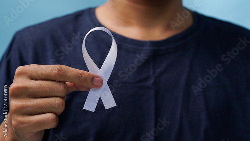man holding a white ribbon in his hand supports world awareness day