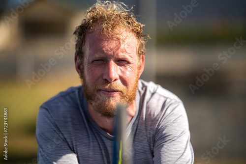 tennis player ready to return serve out in the sun on a tennis court in summer in australia