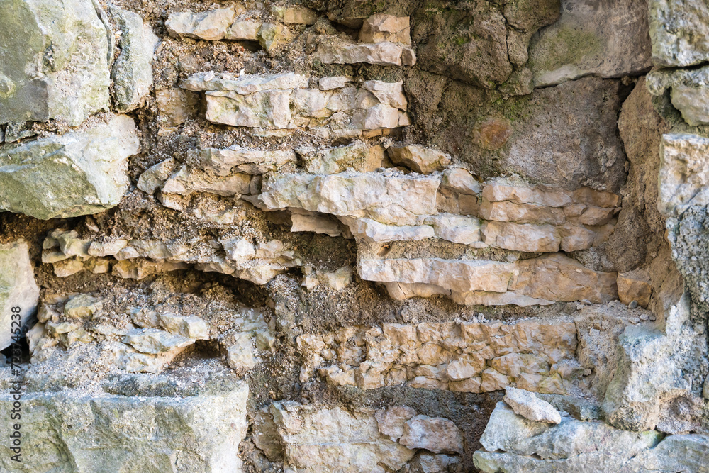 Fragment of a dilapidated medieval stone wall.