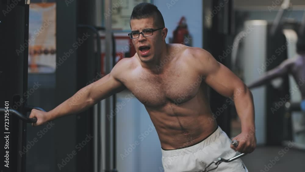 Arab man doing shoulder exercise in the gym. Arab man doing shoulder exercise in the gym.