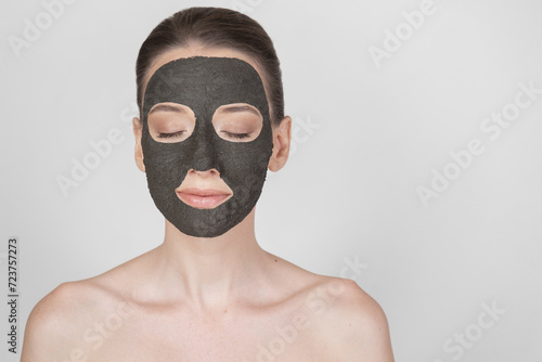 Portrait of a beautiful girl wearing a clay mask