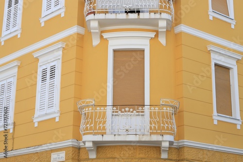 View of beautiful yellow building with balconies outdoors