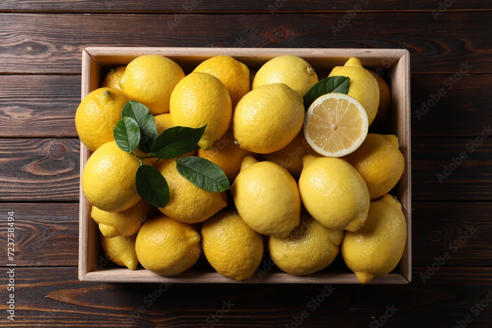 Fresh lemons in crate on wooden table, top view Fresh lemons in crate on wooden table, top view