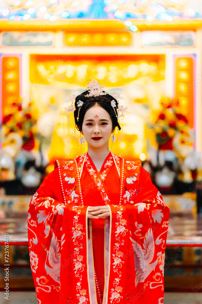 Woman dress China New year. portrait of a woman. person in traditional costume. woman in traditional costume. Beautiful young woman in a bright red dress and a crown of Chinese Queen posing. Woman dress China New year. portrait of a woman. person in traditional costume. woman in traditional costume. Beautiful young woman in a bright red dress and a crown of Chinese Queen posing.