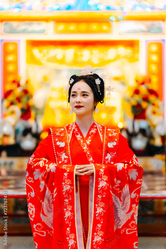 Woman dress China New year. portrait of a woman. person in traditional costume. woman in traditional costume. Beautiful young woman in a bright red dress and a crown of Chinese Queen posing. Woman dress China New year. portrait of a woman. person in traditional costume. woman in traditional costume. Beautiful young woman in a bright red dress and a crown of Chinese Queen posing.