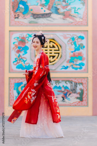 Woman dress China New year. portrait of a woman. person in traditional costume. woman in traditional costume. Beautiful young woman in a bright red dress and a crown of Chinese Queen posing. © Tanarat