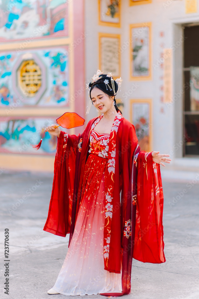 Woman dress China New year. portrait of a woman. person in traditional costume. woman in traditional costume. Beautiful young woman in a bright red dress and a crown of Chinese Queen posing. Woman dress China New year. portrait of a woman. person in traditional costume. woman in traditional costume. Beautiful young woman in a bright red dress and a crown of Chinese Queen posing.
