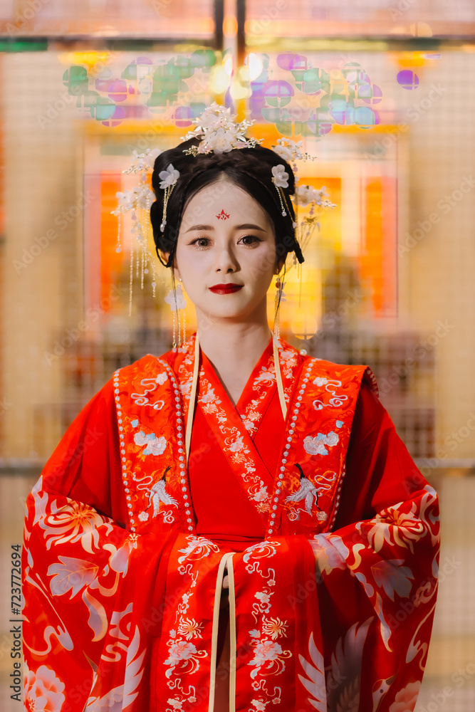 Woman dress China New year. portrait of a woman. person in traditional costume. woman in traditional costume. Beautiful young woman in a bright red dress and a crown of Chinese Queen posing.