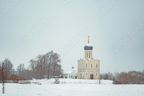 a church in winter in the middle of a snow-covered field