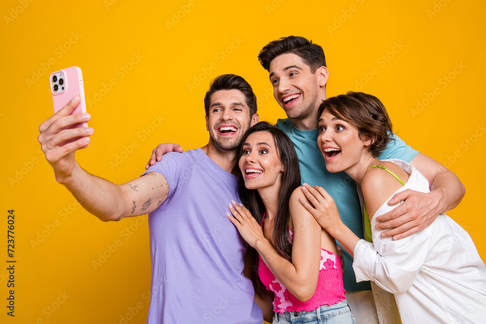 Photo of four people best friends recording video selfie for blog on smart gadget isolated bright color background Photo of four people best friends recording video selfie for blog on smart gadget isolated bright color background