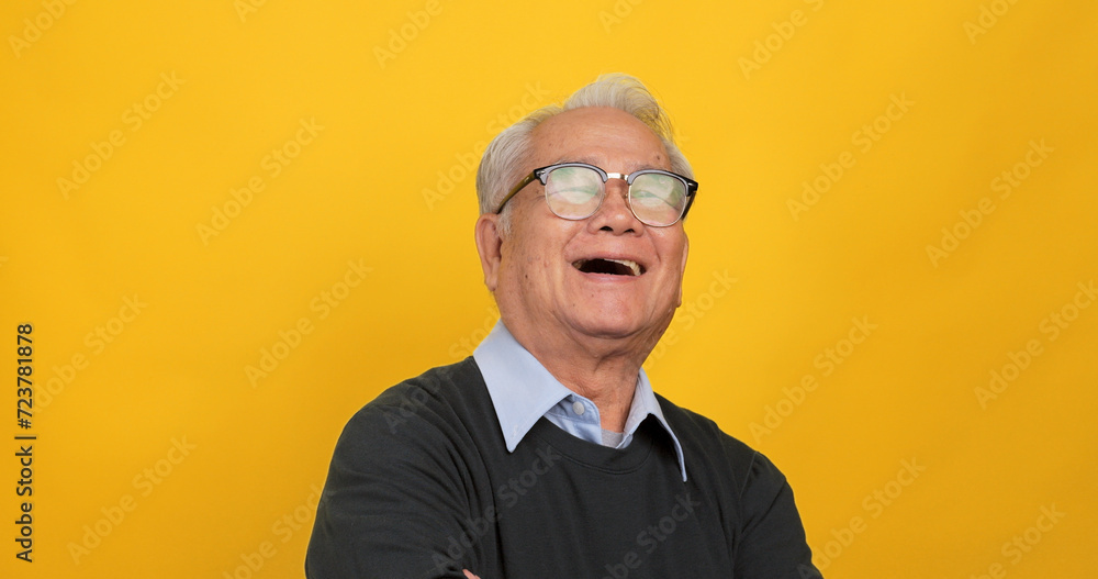 Close up, portrait of older man smiling and looking at the camera. Isolated on yellow background in the studio. Close up, portrait of older man smiling and looking at the camera. Isolated on yellow background in the studio.