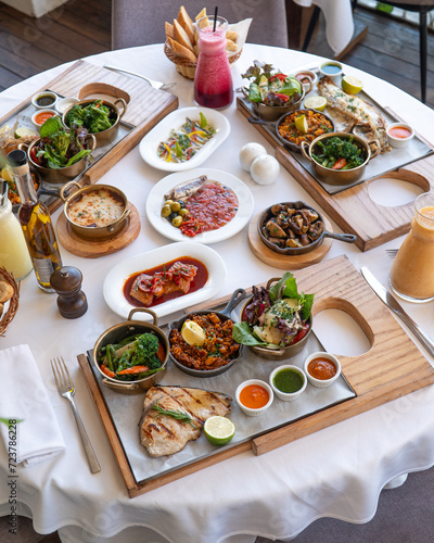 Colorful Spanish food assortment, with fish, paella and vegetables 