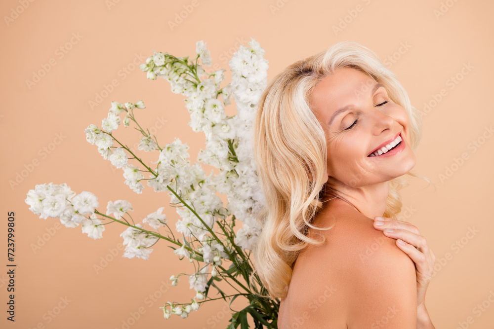 Photo of joyful senior lady touch shoulders applying organic beauty product for flawless clean skin isolated pastel color background Photo of joyful senior lady touch shoulders applying organic beauty product for flawless clean skin isolated pastel color background