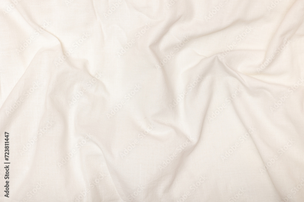 White satin texture with folds. Fabric background. White satin texture with folds. Fabric background.