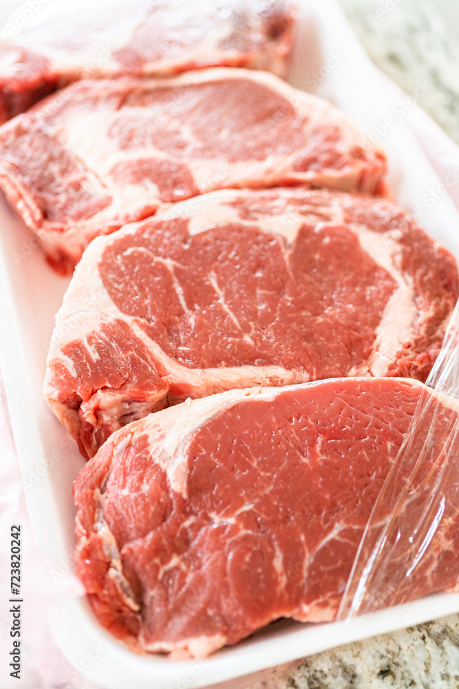 Unpacking Rib Eye Steak in Modern Kitchen Unpacking Rib Eye Steak in Modern Kitchen