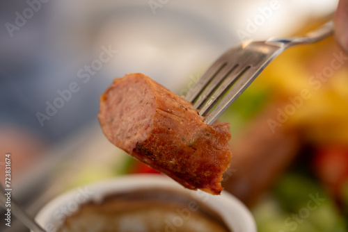 sausage pice on a metalic fork