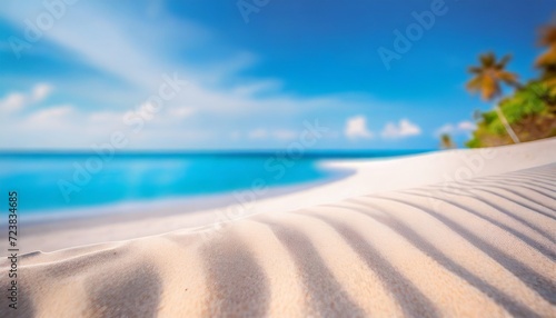 white sand curve or tropical sandy beach with blurry blue ocean and blue sky background image for nature background or summer background
